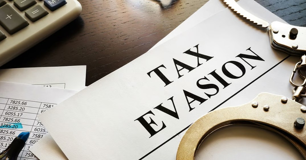 Four booked for evading taxes